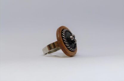 Bague où sont réunis le bois, la nacre et l'acier.