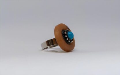 Bague au plateau imitation corne et perle couleur turquoise.